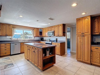 Must see beautiful waterfront pool home in the highly sought on Gulf Harbors Golf Course in Florida - for sale on GolfHomes.com, golf home, golf lot