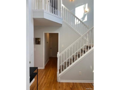 This home's  covered front porch and two story entryway welcomes on Fenton Farms Golf Club in Michigan - for sale on GolfHomes.com, golf home, golf lot