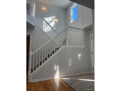 This home's  covered front porch and two story entryway welcomes on Fenton Farms Golf Club in Michigan - for sale on GolfHomes.com, golf home, golf lot