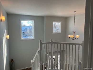 This home's  covered front porch and two story entryway welcomes on Fenton Farms Golf Club in Michigan - for sale on GolfHomes.com, golf home, golf lot