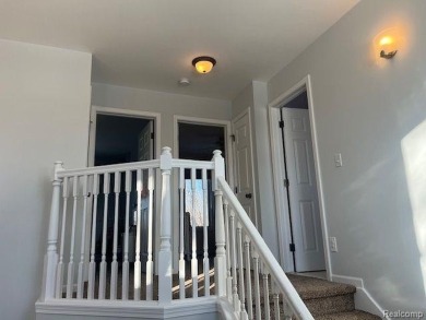 This home's  covered front porch and two story entryway welcomes on Fenton Farms Golf Club in Michigan - for sale on GolfHomes.com, golf home, golf lot