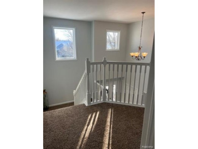 This home's  covered front porch and two story entryway welcomes on Fenton Farms Golf Club in Michigan - for sale on GolfHomes.com, golf home, golf lot