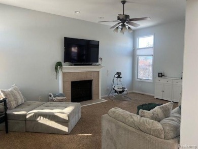 This home's  covered front porch and two story entryway welcomes on Fenton Farms Golf Club in Michigan - for sale on GolfHomes.com, golf home, golf lot