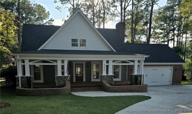 This 4-bedroom, 3.1-bath waterfront property is nestled in the on Gates Four Golf and Country Club in North Carolina - for sale on GolfHomes.com, golf home, golf lot