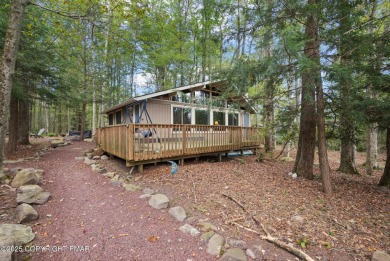 Let the outside in with this beautiful original Lake Naomi cabin on Lake Naomi Timber Trails Golf Club in Pennsylvania - for sale on GolfHomes.com, golf home, golf lot