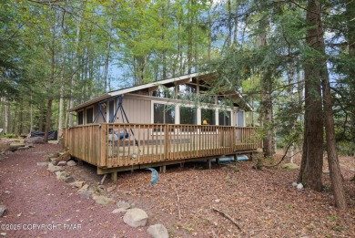Let the outside in with this beautiful original Lake Naomi cabin on Lake Naomi Timber Trails Golf Club in Pennsylvania - for sale on GolfHomes.com, golf home, golf lot