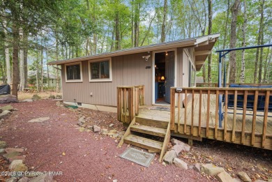 Let the outside in with this beautiful original Lake Naomi cabin on Lake Naomi Timber Trails Golf Club in Pennsylvania - for sale on GolfHomes.com, golf home, golf lot