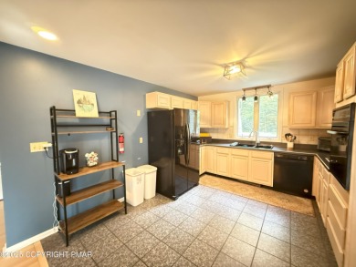 Nestled on a wooded lot backing up to the golf course, this on Pocono Farms Country Club in Pennsylvania - for sale on GolfHomes.com, golf home, golf lot
