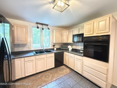 Nestled on a wooded lot backing up to the golf course, this on Pocono Farms Country Club in Pennsylvania - for sale on GolfHomes.com, golf home, golf lot