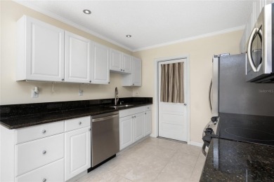Absolutely Charming home nestled on a large fenced yard along a on Port Charlotte Golf Club in Florida - for sale on GolfHomes.com, golf home, golf lot