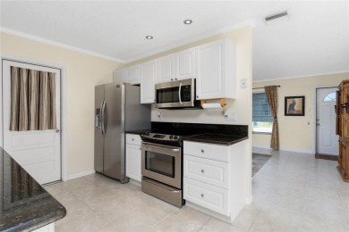 Absolutely Charming home nestled on a large fenced yard along a on Port Charlotte Golf Club in Florida - for sale on GolfHomes.com, golf home, golf lot