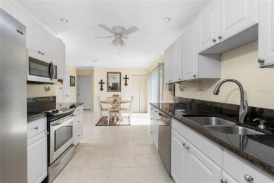 Absolutely Charming home nestled on a large fenced yard along a on Port Charlotte Golf Club in Florida - for sale on GolfHomes.com, golf home, golf lot