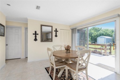 Absolutely Charming home nestled on a large fenced yard along a on Port Charlotte Golf Club in Florida - for sale on GolfHomes.com, golf home, golf lot