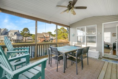 Waterfront house with paved area underneath and nice landscaping on Captains Cove Golf and Yacht Club in Virginia - for sale on GolfHomes.com, golf home, golf lot