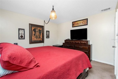 Absolutely Charming home nestled on a large fenced yard along a on Port Charlotte Golf Club in Florida - for sale on GolfHomes.com, golf home, golf lot