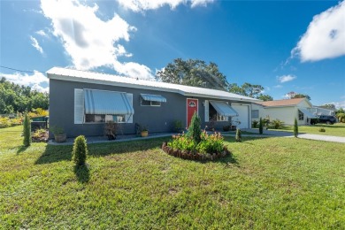 Absolutely Charming home nestled on a large fenced yard along a on Port Charlotte Golf Club in Florida - for sale on GolfHomes.com, golf home, golf lot