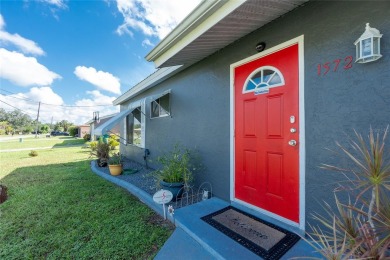 Absolutely Charming home nestled on a large fenced yard along a on Port Charlotte Golf Club in Florida - for sale on GolfHomes.com, golf home, golf lot