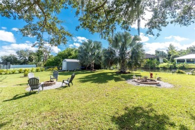 Absolutely Charming home nestled on a large fenced yard along a on Port Charlotte Golf Club in Florida - for sale on GolfHomes.com, golf home, golf lot