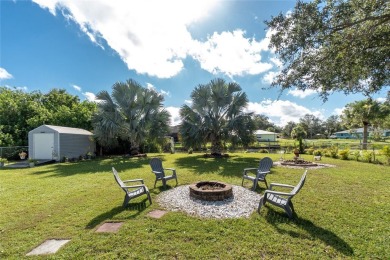 Absolutely Charming home nestled on a large fenced yard along a on Port Charlotte Golf Club in Florida - for sale on GolfHomes.com, golf home, golf lot