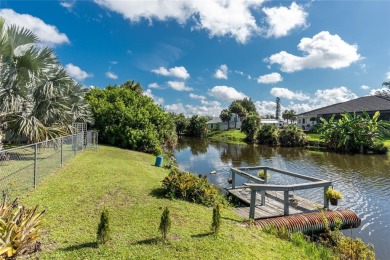 Absolutely Charming home nestled on a large fenced yard along a on Port Charlotte Golf Club in Florida - for sale on GolfHomes.com, golf home, golf lot
