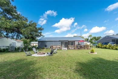 Absolutely Charming home nestled on a large fenced yard along a on Port Charlotte Golf Club in Florida - for sale on GolfHomes.com, golf home, golf lot