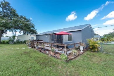 Absolutely Charming home nestled on a large fenced yard along a on Port Charlotte Golf Club in Florida - for sale on GolfHomes.com, golf home, golf lot