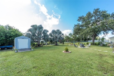 Absolutely Charming home nestled on a large fenced yard along a on Port Charlotte Golf Club in Florida - for sale on GolfHomes.com, golf home, golf lot