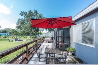 Absolutely Charming home nestled on a large fenced yard along a on Port Charlotte Golf Club in Florida - for sale on GolfHomes.com, golf home, golf lot