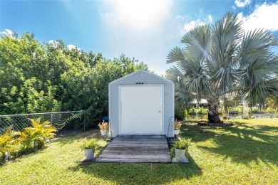 Absolutely Charming home nestled on a large fenced yard along a on Port Charlotte Golf Club in Florida - for sale on GolfHomes.com, golf home, golf lot