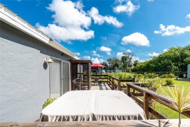 Absolutely Charming home nestled on a large fenced yard along a on Port Charlotte Golf Club in Florida - for sale on GolfHomes.com, golf home, golf lot