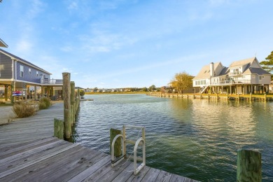 Waterfront house with paved area underneath and nice landscaping on Captains Cove Golf and Yacht Club in Virginia - for sale on GolfHomes.com, golf home, golf lot