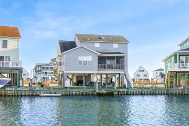 Waterfront house with paved area underneath and nice landscaping on Captains Cove Golf and Yacht Club in Virginia - for sale on GolfHomes.com, golf home, golf lot