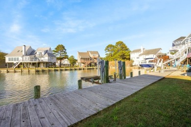 Waterfront house with paved area underneath and nice landscaping on Captains Cove Golf and Yacht Club in Virginia - for sale on GolfHomes.com, golf home, golf lot