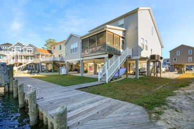 Waterfront house with paved area underneath and nice landscaping on Captains Cove Golf and Yacht Club in Virginia - for sale on GolfHomes.com, golf home, golf lot