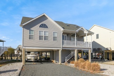 Waterfront house with paved area underneath and nice landscaping on Captains Cove Golf and Yacht Club in Virginia - for sale on GolfHomes.com, golf home, golf lot