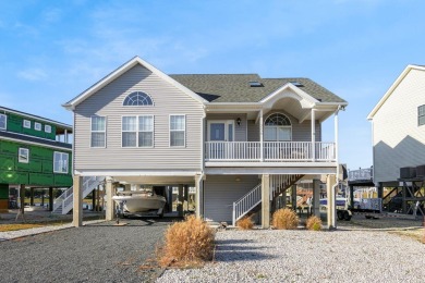 Waterfront house with paved area underneath and nice landscaping on Captains Cove Golf and Yacht Club in Virginia - for sale on GolfHomes.com, golf home, golf lot