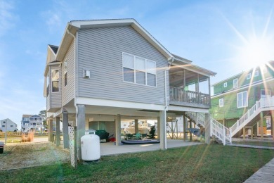 Waterfront house with paved area underneath and nice landscaping on Captains Cove Golf and Yacht Club in Virginia - for sale on GolfHomes.com, golf home, golf lot