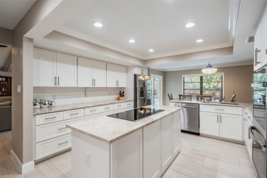 Discover this beautifully updated, move-in-ready pool home on East Lake Woodlands Country Club in Florida - for sale on GolfHomes.com, golf home, golf lot