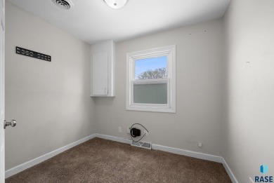 Cute as a button! This quaint one-level home is sure to impress on Elmwood Park Golf Course in South Dakota - for sale on GolfHomes.com, golf home, golf lot