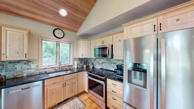 Step into this immaculate custom home, perfectly situated with on Michaywe Pines Course in Michigan - for sale on GolfHomes.com, golf home, golf lot