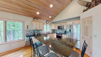Step into this immaculate custom home, perfectly situated with on Michaywe Pines Course in Michigan - for sale on GolfHomes.com, golf home, golf lot