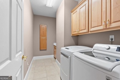 FIRST TIME ON THE MARKET! This exquisite 4-side blush brick on Royal Lakes Golf and Country Club in Georgia - for sale on GolfHomes.com, golf home, golf lot