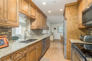 Located in the heart of Palm Harbor, 102 Stanford Drive is on Highland Lakes Executive Golf Course in Florida - for sale on GolfHomes.com, golf home, golf lot