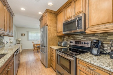 Located in the heart of Palm Harbor, 102 Stanford Drive is on Highland Lakes Executive Golf Course in Florida - for sale on GolfHomes.com, golf home, golf lot