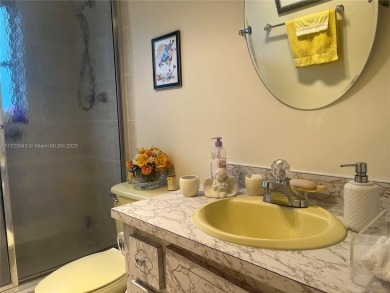 Experience luxury in this coveted first-floor corner residence on Palm-Aire Country Club and Resort - Palms in Florida - for sale on GolfHomes.com, golf home, golf lot