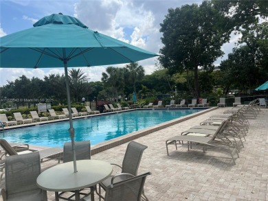 Experience luxury in this coveted first-floor corner residence on Palm-Aire Country Club and Resort - Palms in Florida - for sale on GolfHomes.com, golf home, golf lot