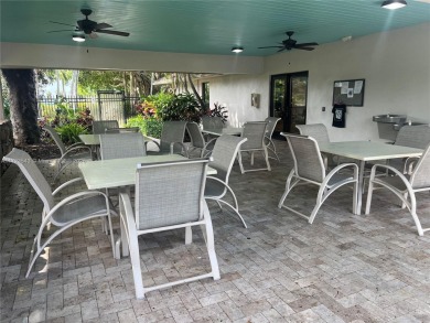 Experience luxury in this coveted first-floor corner residence on Palm-Aire Country Club and Resort - Palms in Florida - for sale on GolfHomes.com, golf home, golf lot