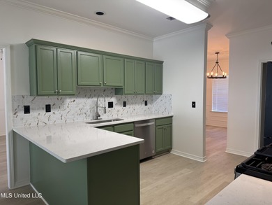 Welcome home to this recently updated 3-bedroom, 2-bath brick on Diamondhead Country Club in Mississippi - for sale on GolfHomes.com, golf home, golf lot