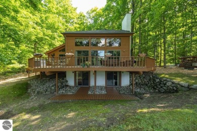 Tucked away in a private setting with frontage on the 13th hole on Schuss Mountain Golf Club in Michigan - for sale on GolfHomes.com, golf home, golf lot