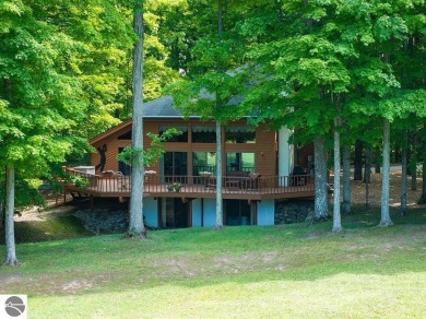 Tucked away in a private setting with frontage on the 13th hole on Schuss Mountain Golf Club in Michigan - for sale on GolfHomes.com, golf home, golf lot